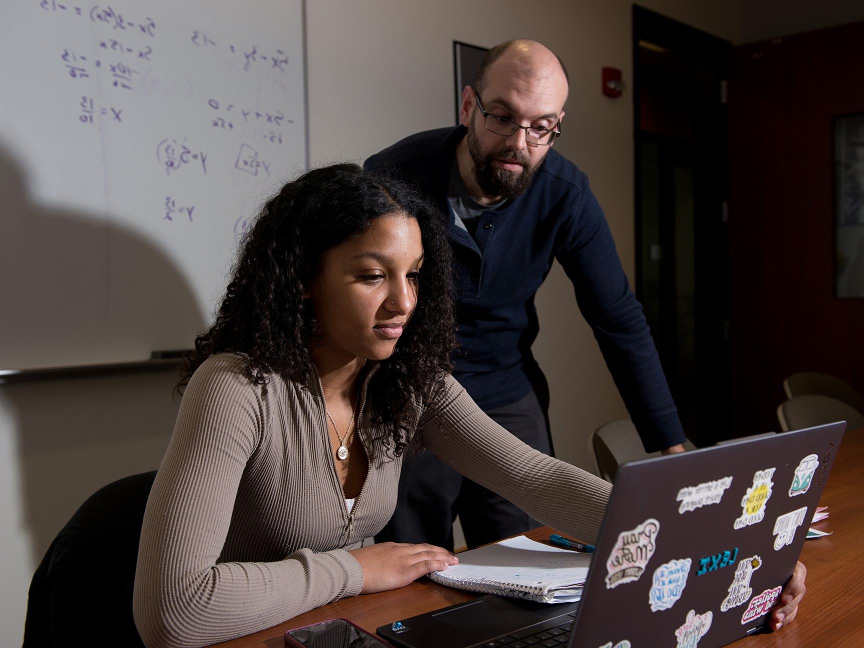 A student and faculty member working in the Math Center